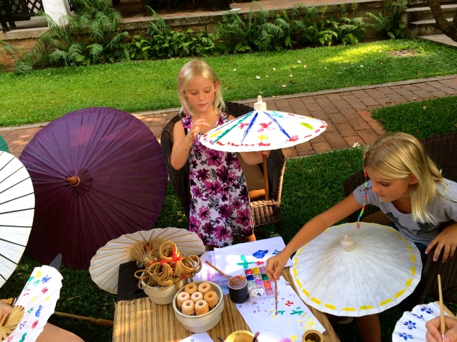 Thayer and Zoe do some Thai umbrella painting